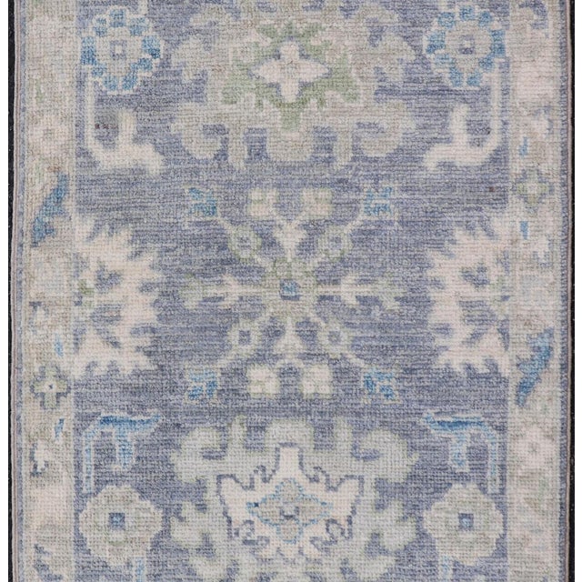 Measures: 1'10 x 3'0 Modern Oushak Rug with Serene Blue Tones and Soft Ivory and Sage 1'10 x 3'0. Keivan Woven Arts; rug...