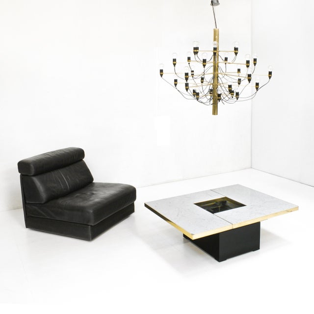 A Paul Michel 1970s coffee table executed in white marble with brass trim. This combination in materials is rarely seen on...