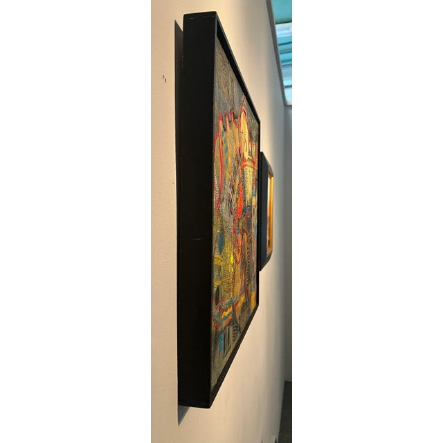 This abstract collage features a complex composition of colors, shapes, and textures. The dominant colors include shades...