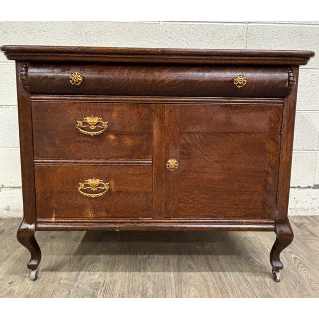 This is a beautiful antique Victorian or Edwardian tiger oak sideboard, buffet, or console, circa 1890–1910, crafted from...