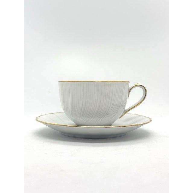 Tea cup and saucer sets in the Verlaine pattern by Bernardaud. See photos for exact measurements.
