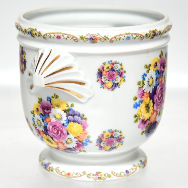 A Parisian cachepot/vase having a colourful and exuberant floral bouquet motif emanating euphoric vibes, accented with...