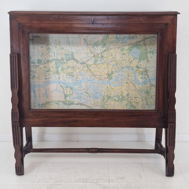 An exceptionally rare and highly specialized late 19th century cartographic display cabinet, masterfully crafted in solid...
