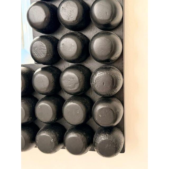 The Paxton mirror is filled with visual and tactile textures. Every knob is hand carved from solid wood then affixed to...