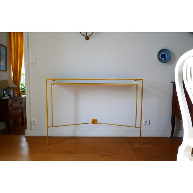 Custom-made console in patinated bronze-gilt metal and walnut wood.