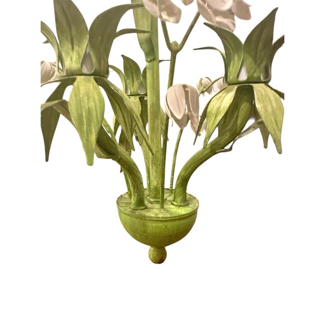 A stunning, vintage, Italian tole chandelier. Features a hand painted tole chandelier adorned with green leaves, and...