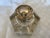 A heavy 6 sided glass inkwell, with a sterling repousse hinged top. The piece is marked with a flag and the word....