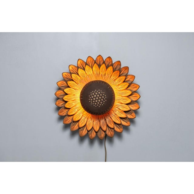 This ceramic sunflower wall lamp crafted by Berth Ferdinand Norrman is an exquisite example of both functional art and...