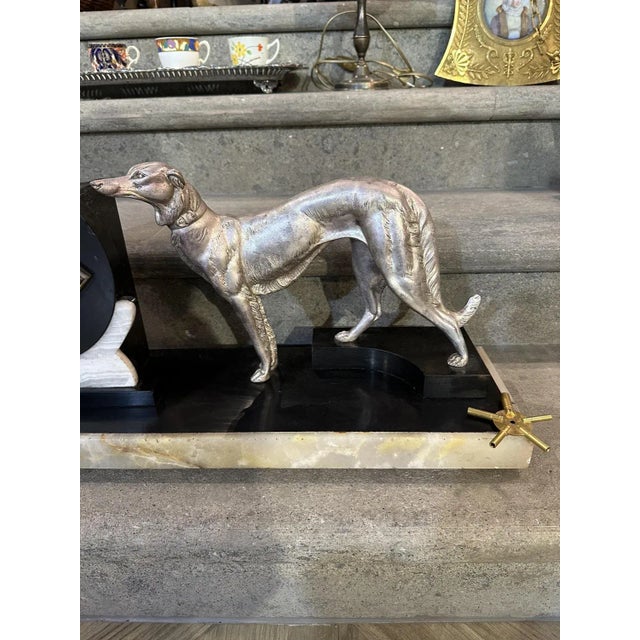 Art Deco Clock in Black and White Marble with Metal Greyhound and Rhomboidal Dial, 1930s, in Very Good conditions....
