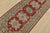 A tribal Caucasian Kazak runner hand-knotted with fine wool on a cotton foundation. This rug features geometric medallions...