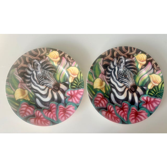 Twin zebras in a fantasy setting of bright juicy colors like hot pink, chartreuse, orange, and black. Is it a Banana Rama...