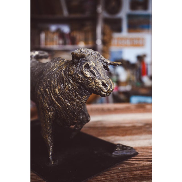 A unique work of art—a bronze and iron bull created by Bergamo artist Ivan Cattaneo. It measures 35 x 18 cm at the base...