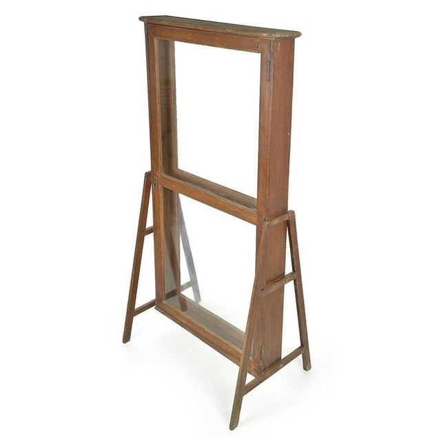 with its slender appearance and through opening, this double-sided display case evokes old workshop or boutique display...