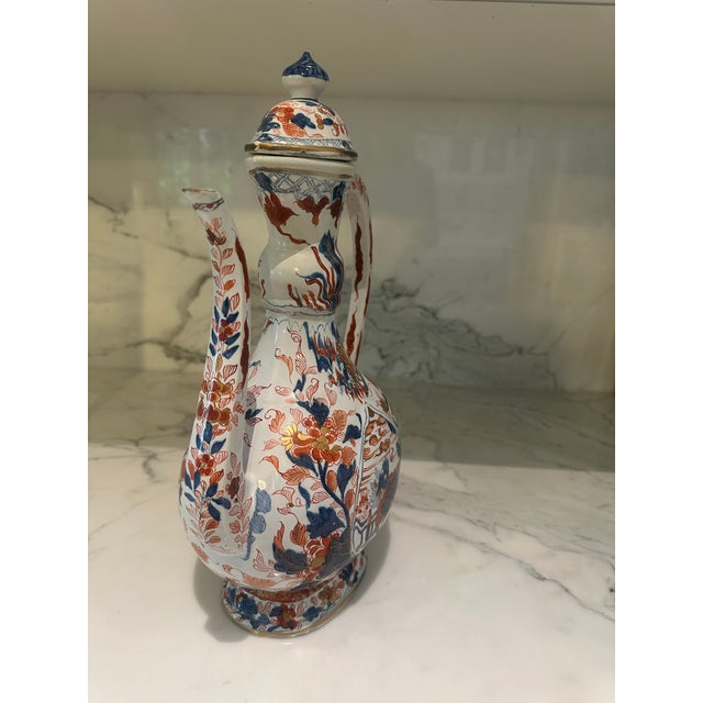 A beautiful covered Ewer, Japanese, 17th-18th century, decorated in underglaze blue, Imari colors and gilding with floral...