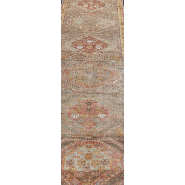 Measures: 2'11 x 10'11 Vintage Turkish Oushak Runner with Tribal Medallions in Brown's, Yellow, and Red. Keivan Woven Arts...