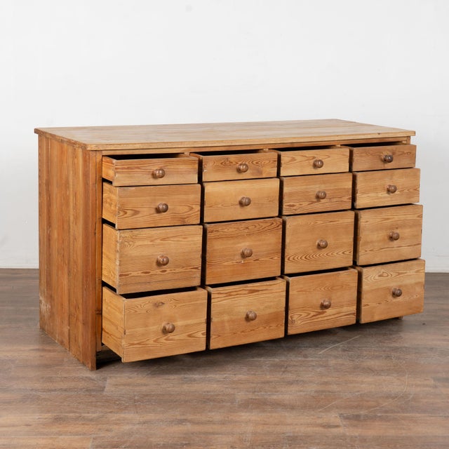 Fun and function combine in this pine counter with 16 drawers. This delightful pine apothecary originally served as a shop...