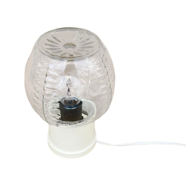 Mid-century modern bedside lamp made in Belgium in the 1970s for Massive Leuchten. Shade made of pressed glass, mounted on...