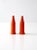 Vibrant vintage push-top salt and pepper shakers in bright orange plastic with a modern, streamlined silhouette. The...