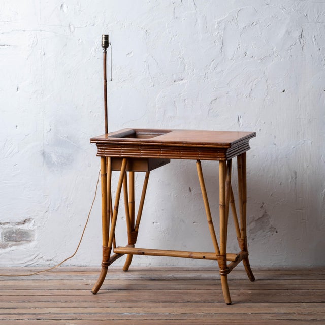 A bamboo jardiniere and lamp table, mid-20th century. 25 inches wide by 17 ¼ inches deep by 26 ¾ inches tall