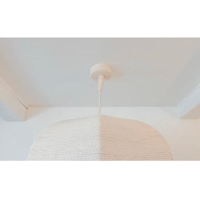 This is a custom light fixture made by Artisans. Its made of cotton rope. The drops can be made at your desired length.