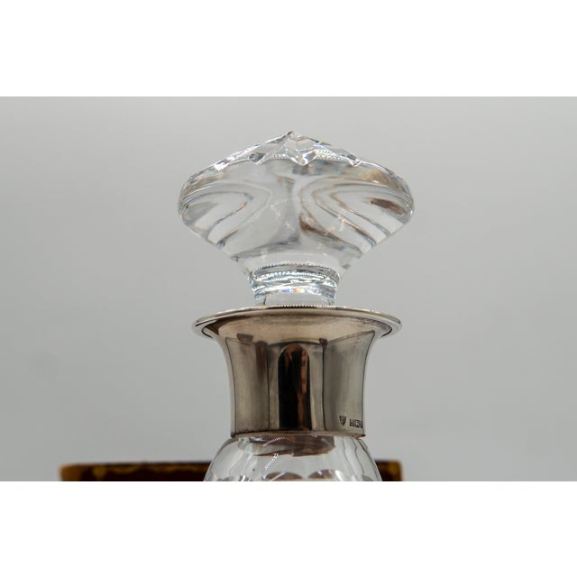 Hallmarked Birmingham 1975, this vintage crystal decanter has a sterling silver collar with the Maker's Mark of J B...