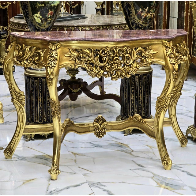Beautiful large console table featuring a light-colored marble top. Fully refinished in new gold leaf for a fresh,...