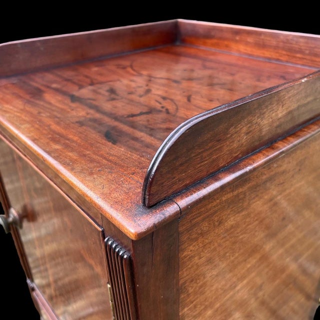 A fine quality Regency Period Gillows (Attrib) mahogany bedside cupboard. Having a raised gallery with reeded detail and a...