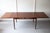 An extending teak dining table, designed by Ib Kofed-Larsen with a beautiful sculptured apron and elegant tapered legs,...