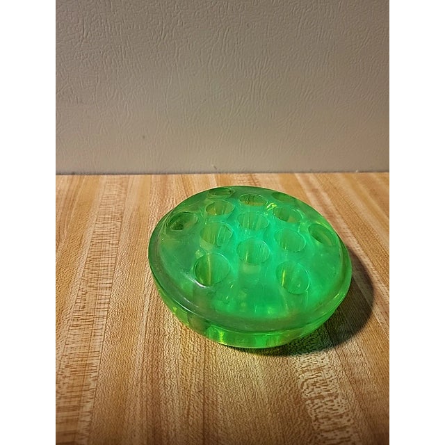 1930s vintage uranium glass floral frog with 13 holes. Flourescent glass glows under a black light.