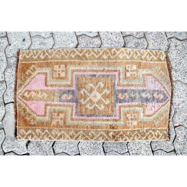 This is a vintage Turkish Oushak rug from the 1960s. The piece was hand-knotted.