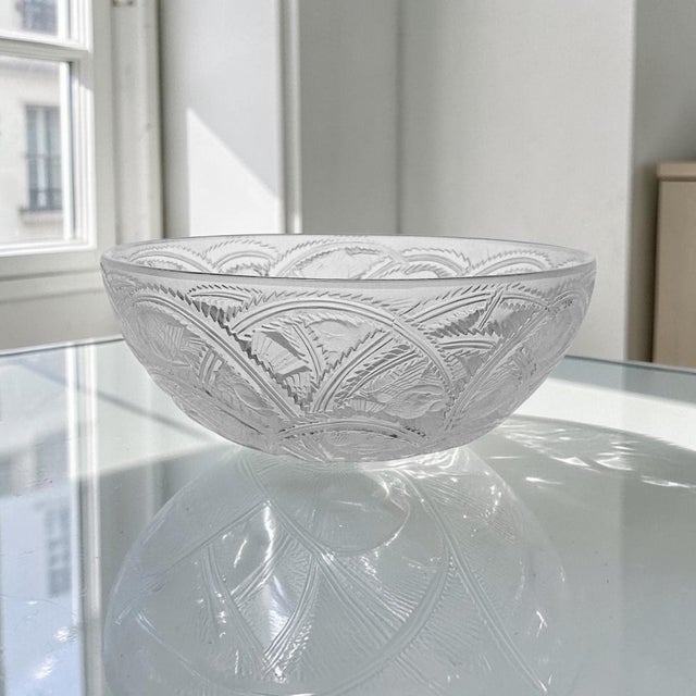 This Lalique France Pinsons crystal centerpiece bowl was produced in Wingen-sur-Moder, France during the Mid 20th Century,...