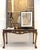 Italian Neoclassical / Louis XV style giltwood console, late 20th century, with Emperador marble top.” An elegant giltwood...