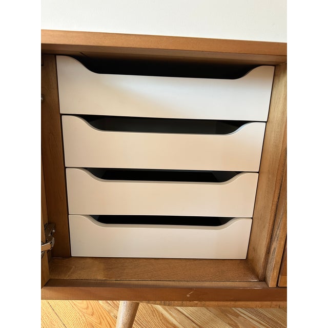 Beautiful vintage mid-century modern sideboard featuring warm, honey-toned wood with a naturally varied grain and softly...