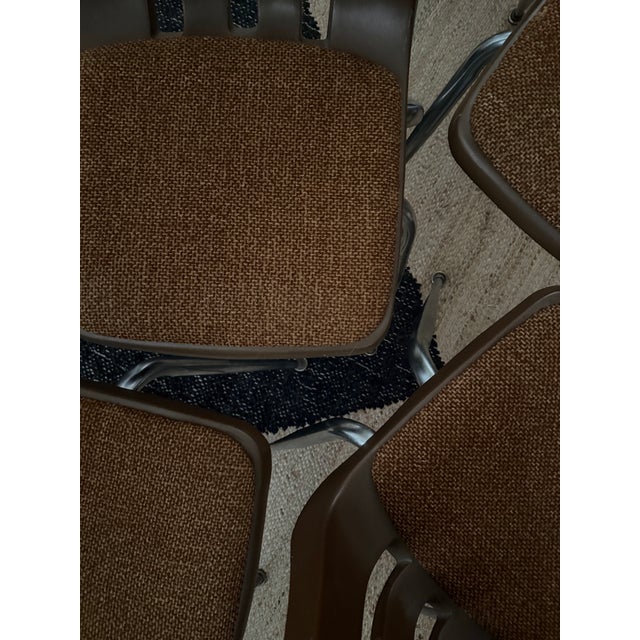 Set of four retro modern tobacco brown chairs featuring molded Virco shells and original textured upholstery. Retains...