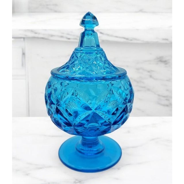 Indulge in the timeless beauty of this Vintage Fostoria Footed Candy Dish with Lid, inspired by the iconic collection...