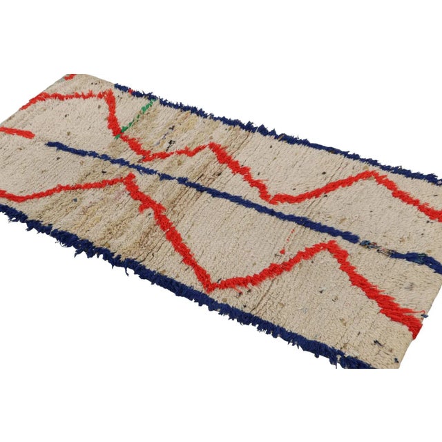 Hand-knotted in wool, circa 1950-1960, this 2x5 vintage Moroccan runner rug is believed to hail from the Azilal tribe. On...