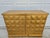 A beautiful diamond pattern gold leaf cabinet or credenza by Barbara Barry for Baker Furniture. This piece features a...