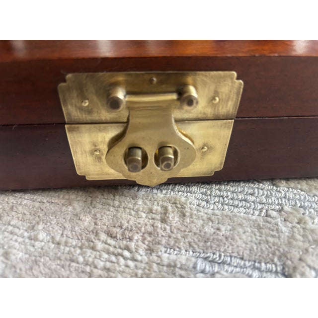 An Asian style Brass Bound Rosewood Jewelry Box, dovetailed construction, with a central brass boss on the top and brass...