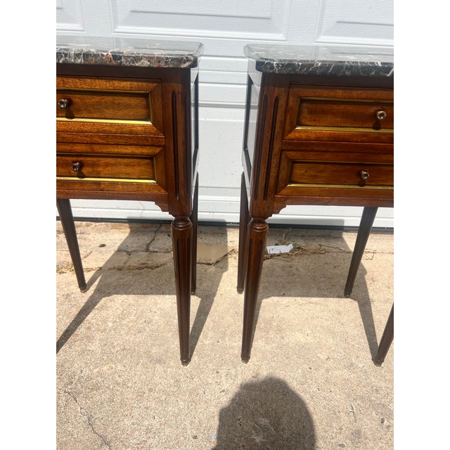 Elegant pair of 19th-century French Louis XVI nightstands crafted in fine walnut with beautifully figured veneers. Each...