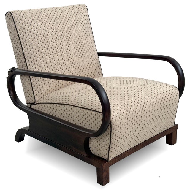 Elegant reclining armchair from the Art Deco period, dating to the 1930s. The chair features beautifully curved wooden...