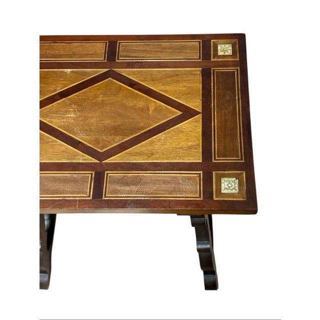 Low auxiliary table Circa 1940, made of walnut wood, with marquetry on the top, carved lyre legs and wrought iron...