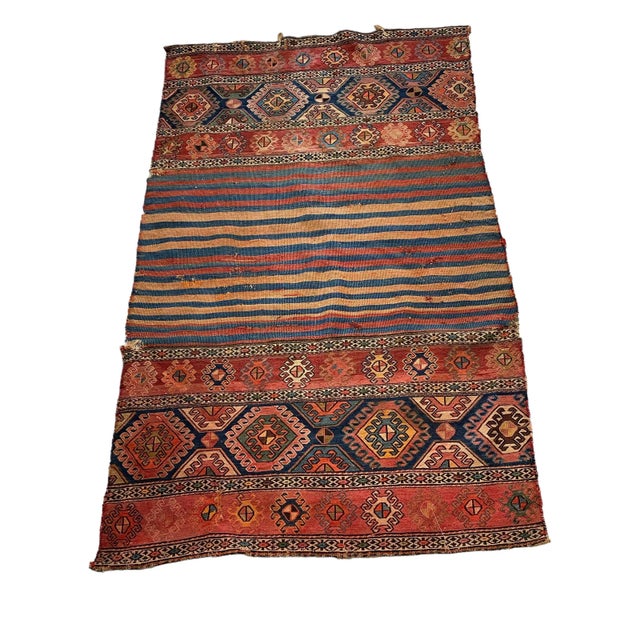 This Antique and Rare Tribal Caucasian Kuba Kilim stands at 5'42" by 3'42" (65" h by 41" w) and dates back to the late...