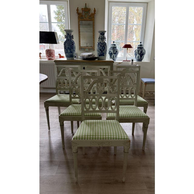 Six chairs with cut-out decoration and openwork backrests, in the so-called "zero model" style. The chairs are crafted in...