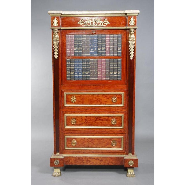 Noble veneer on solid softwood. Rectangular body on chiseled bronze claw feet. Architecturally structured front with dummy...