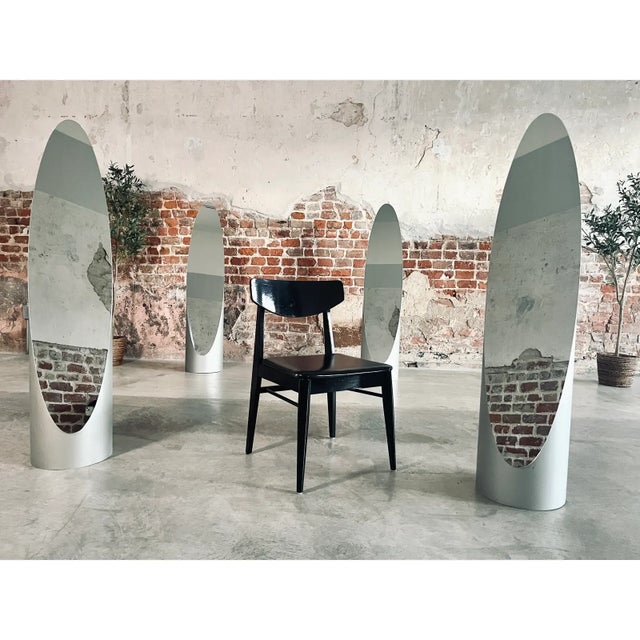 1960s vintage Danish modern side chair with a black lacquered wood frame and black vinyl seat. The design reflects classic...