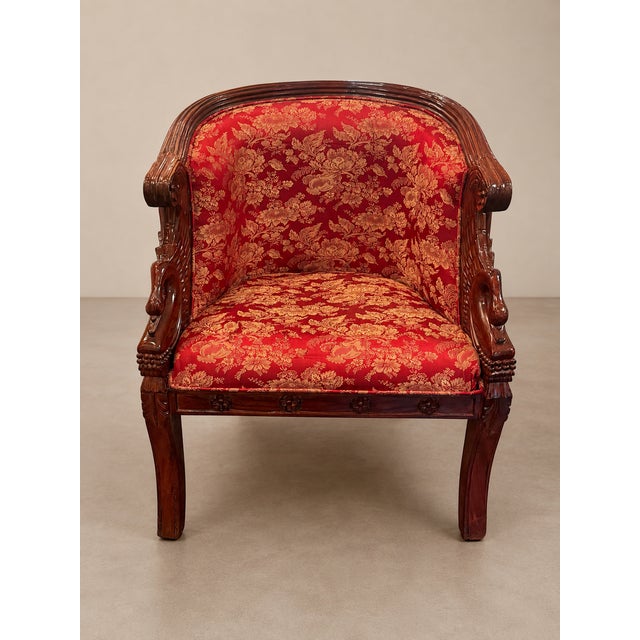 Striking early 20th century carved mahogany barrel chair featuring dramatic sculptural swan-form arms, layered feather...