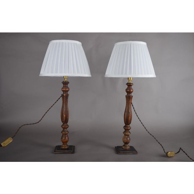 A beautiful pair of vintage turned wood table lamps (set of 2), finished in a rich dark tone with warm, time-earned...