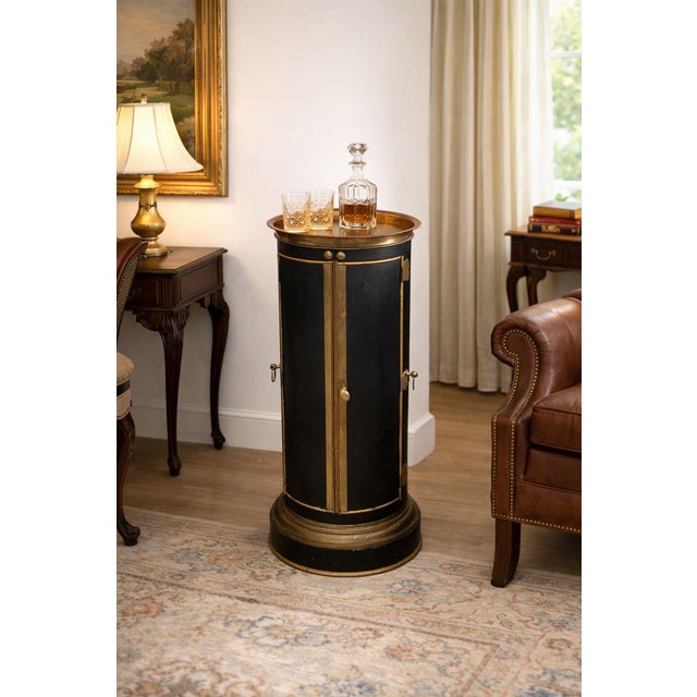 This rare English warming tower is an exceptional example of early 19th-century domestic utility design. Crafted in black-...