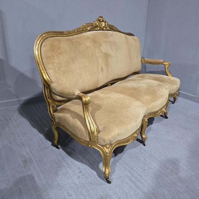 Outstanding French large double serpentine gilt country house couch, upholsered in oatmeal suede, in overall superb...
