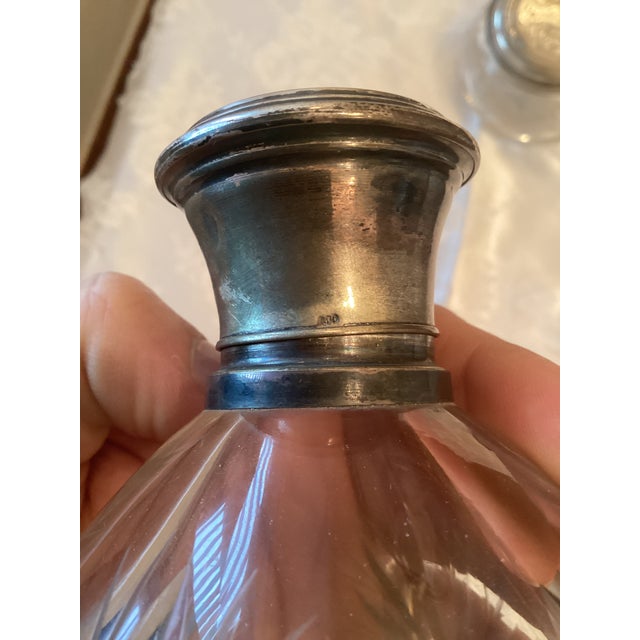 Refined vintage toiletry set, composed of four matching pieces, crafted from engraved glass and fitted with 800 silver....